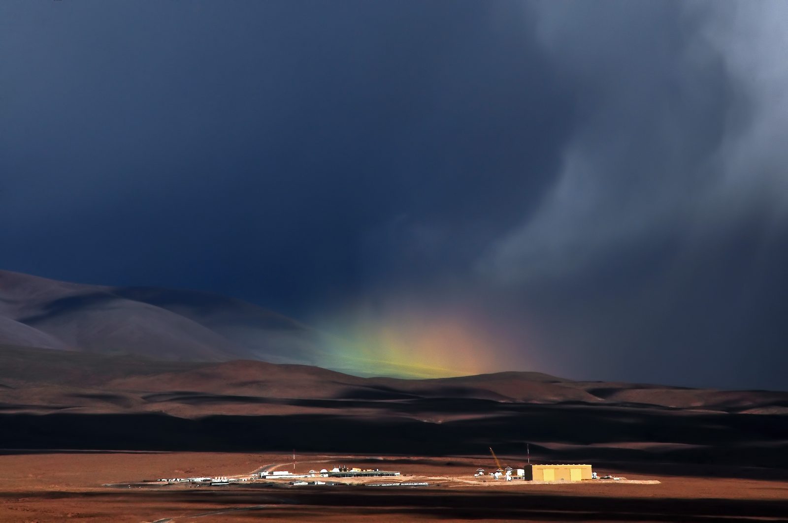 A rare rainbow arching over ALMA's Operations Support Facility in the high desert near San Pedro de Atacama