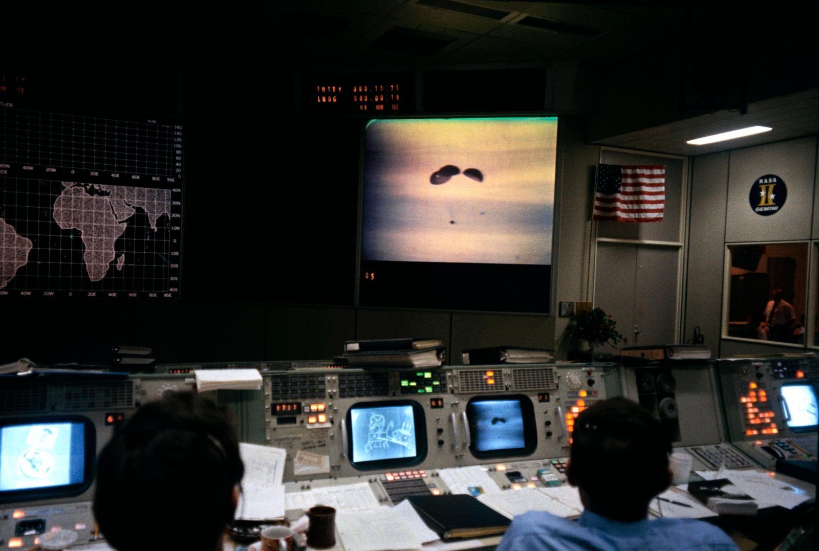 Flight controllers at their consoles in Mission Control in Houston as Apollo 13 splashes down, April 1970