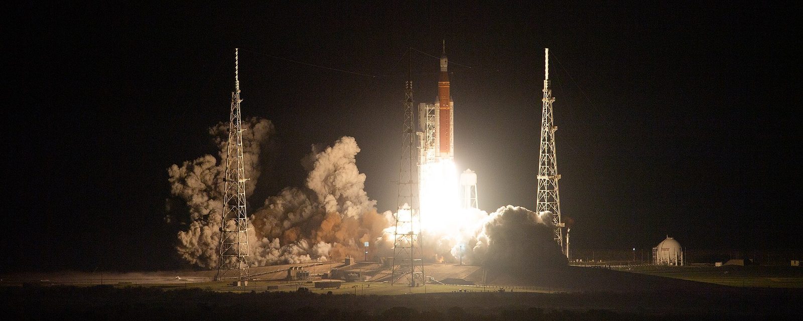 NASA's Space Launch System rocket lifting off on Artemis I from Kennedy Space Center at night