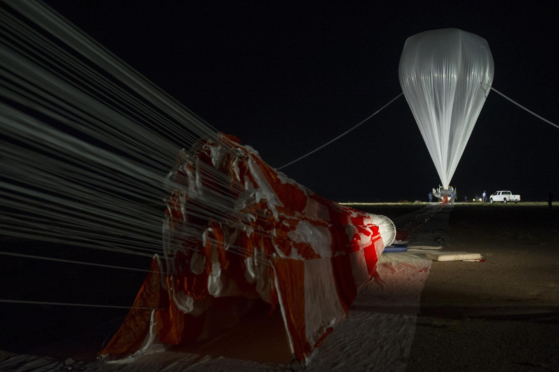 A NASA scientific balloon inflating with helium before a pre-dawn launch at Fort Sumner, New Mexico