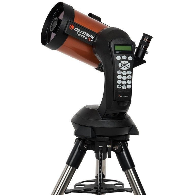 Celestron NexStar 5SE with its orange 5-inch tube on the single-arm computerized mount, hand control in its cradle