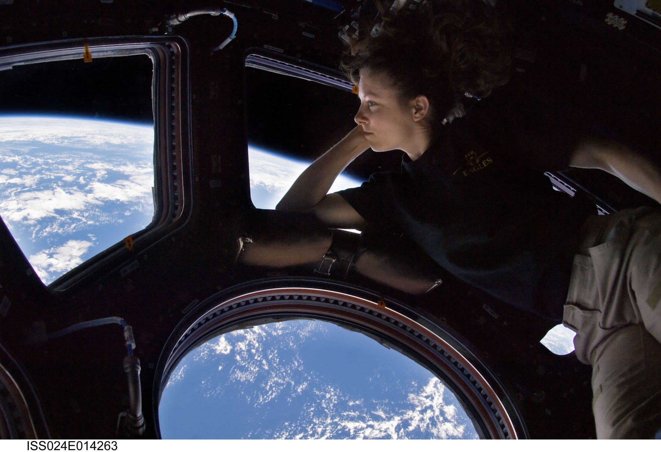 Astronaut Tracy Caldwell Dyson gazing down at Earth from the ISS Cupola