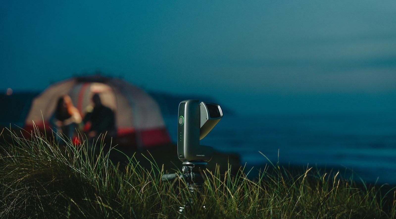 DwarfLab Dwarf Mini smart telescope imaging the night sky beside a lit tent at a campsite
