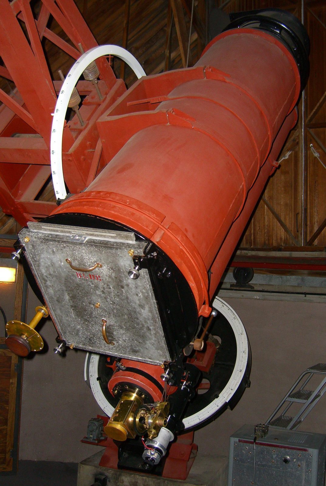 Lowell Observatory&rsquo;s 13-inch f/5.3 astrograph in its dome in Flagstaff, Arizona, the red tube angled down with a 14x17-inch glass plate holder latched to its back