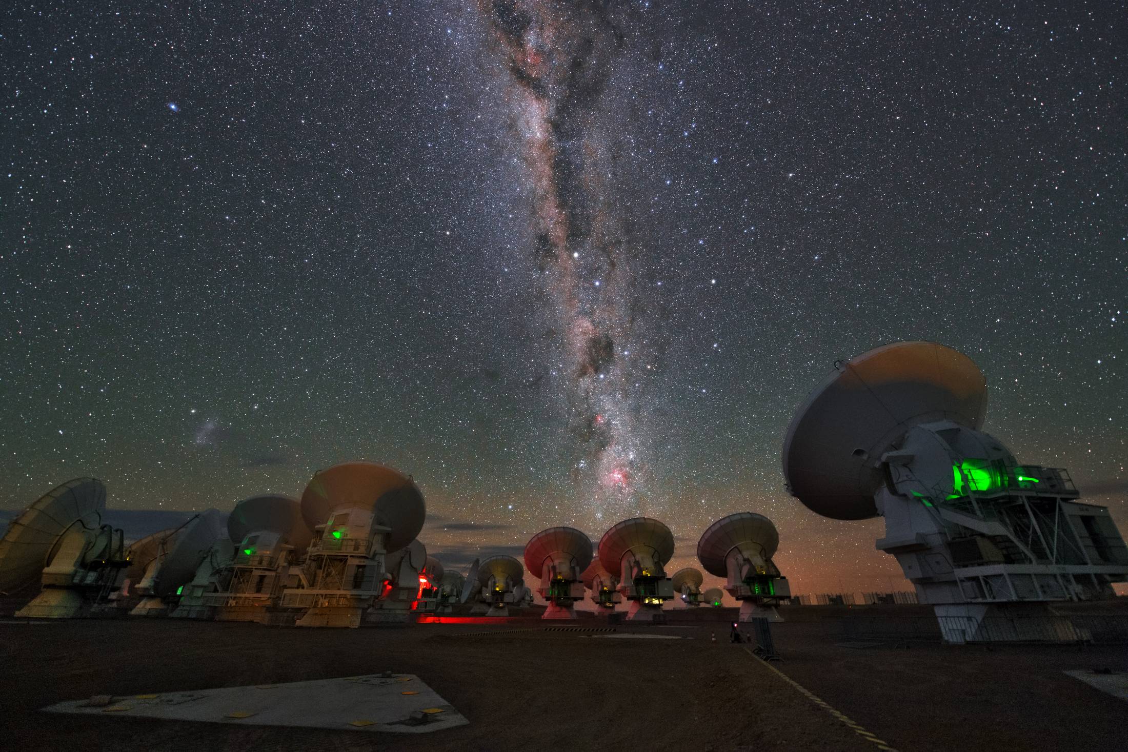 The Milky Way rising over the radio antennas of the ALMA observatory on the Chajnantor plateau, above San Pedro de Atacama, Chile