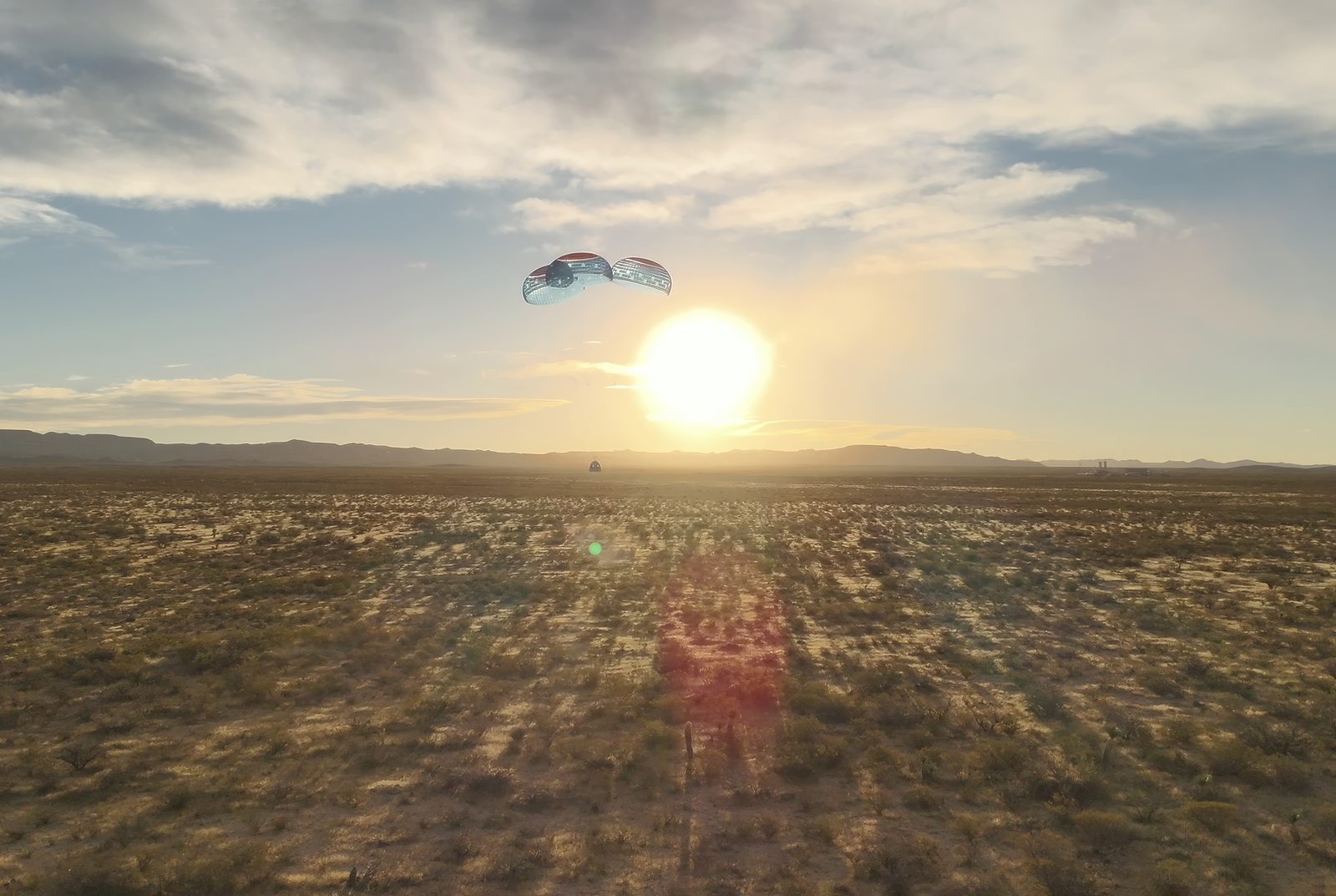 A crew capsule descending safely under its main parachutes