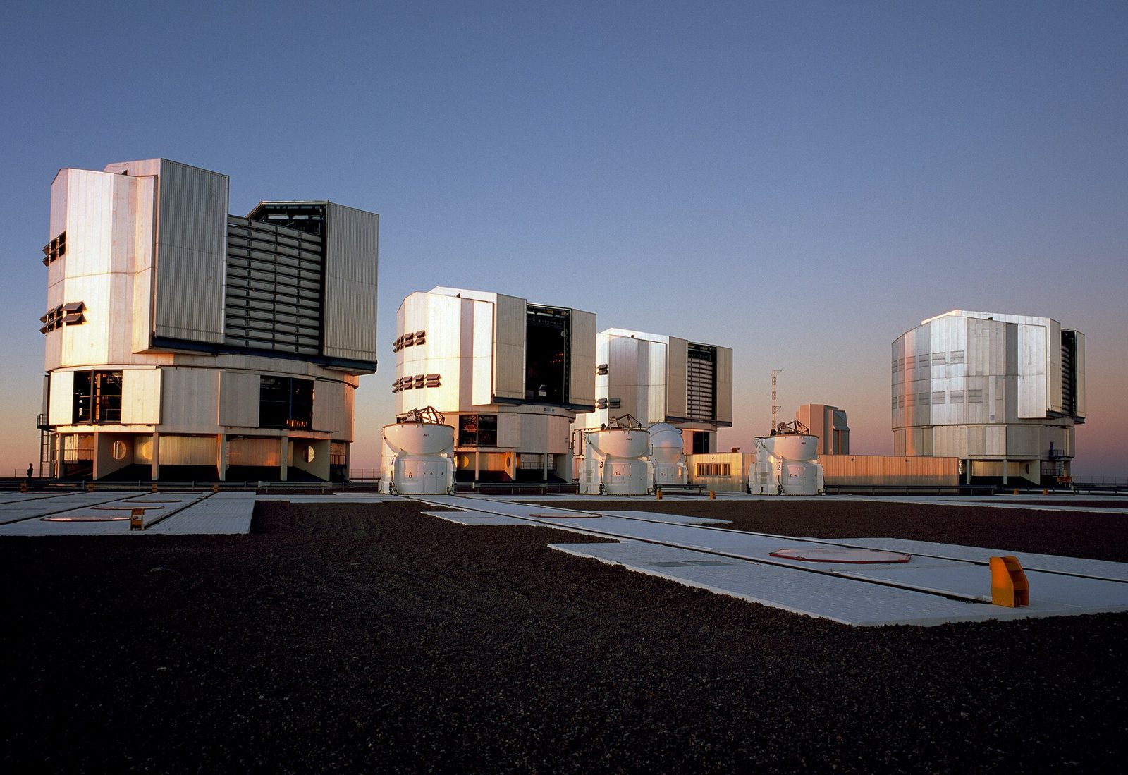 An observatory dome open to a star-filled night sky