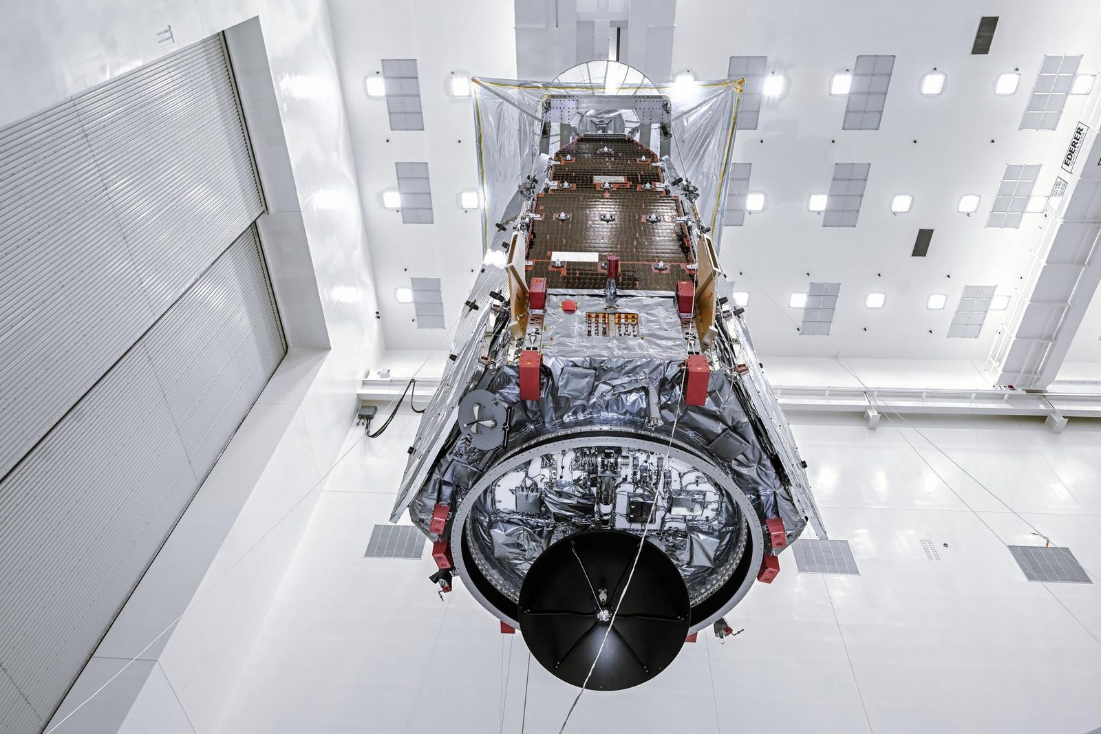 NASA&rsquo;s Nancy Grace Roman Space Telescope lifted by crane to a work stand inside the clean room at Kennedy Space Center