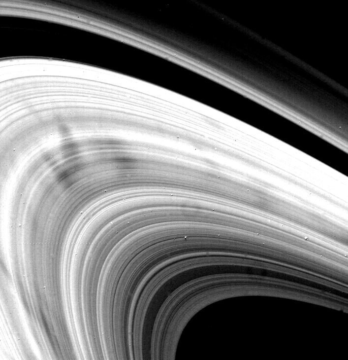 Dark wedge-shaped spokes across the bright B-ring of Saturn, photographed by Voyager 2 in 1981