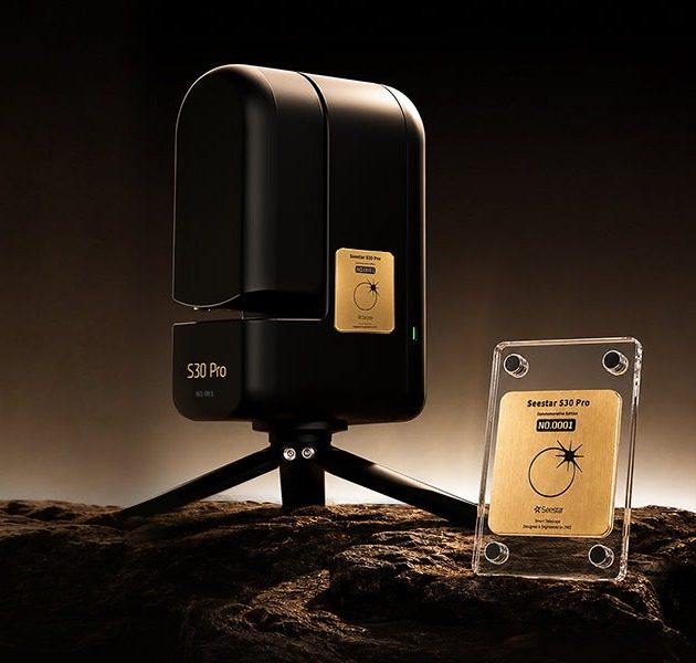 ZWO Seestar S30 Pro Eclipse Edition in tea-black beside its numbered commemorative card in an acrylic stand