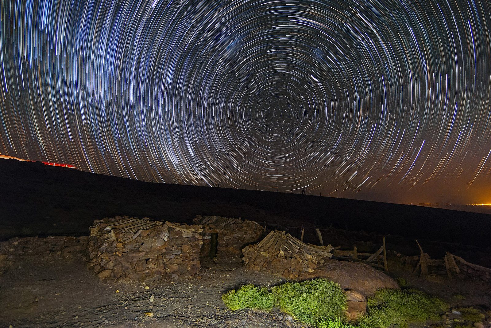 Star trails wheeling over an observatory through the night