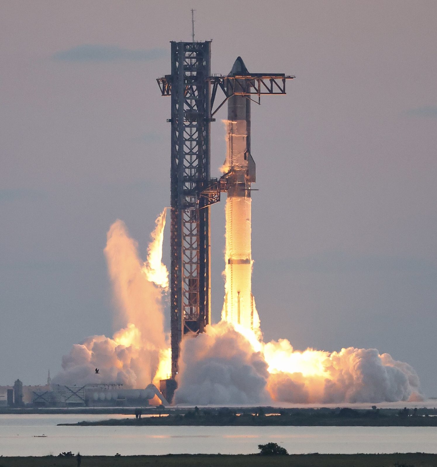 SpaceX’s Starship climbing off the pad — central to the company’s future crewed flights