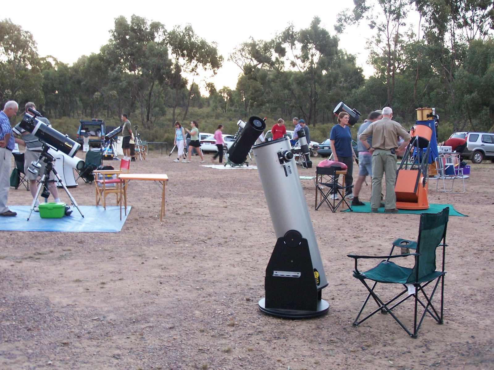 Stargazers setting up telescopes on an observing field under a dark sky &mdash; the real-world start of the hobby this guide is about