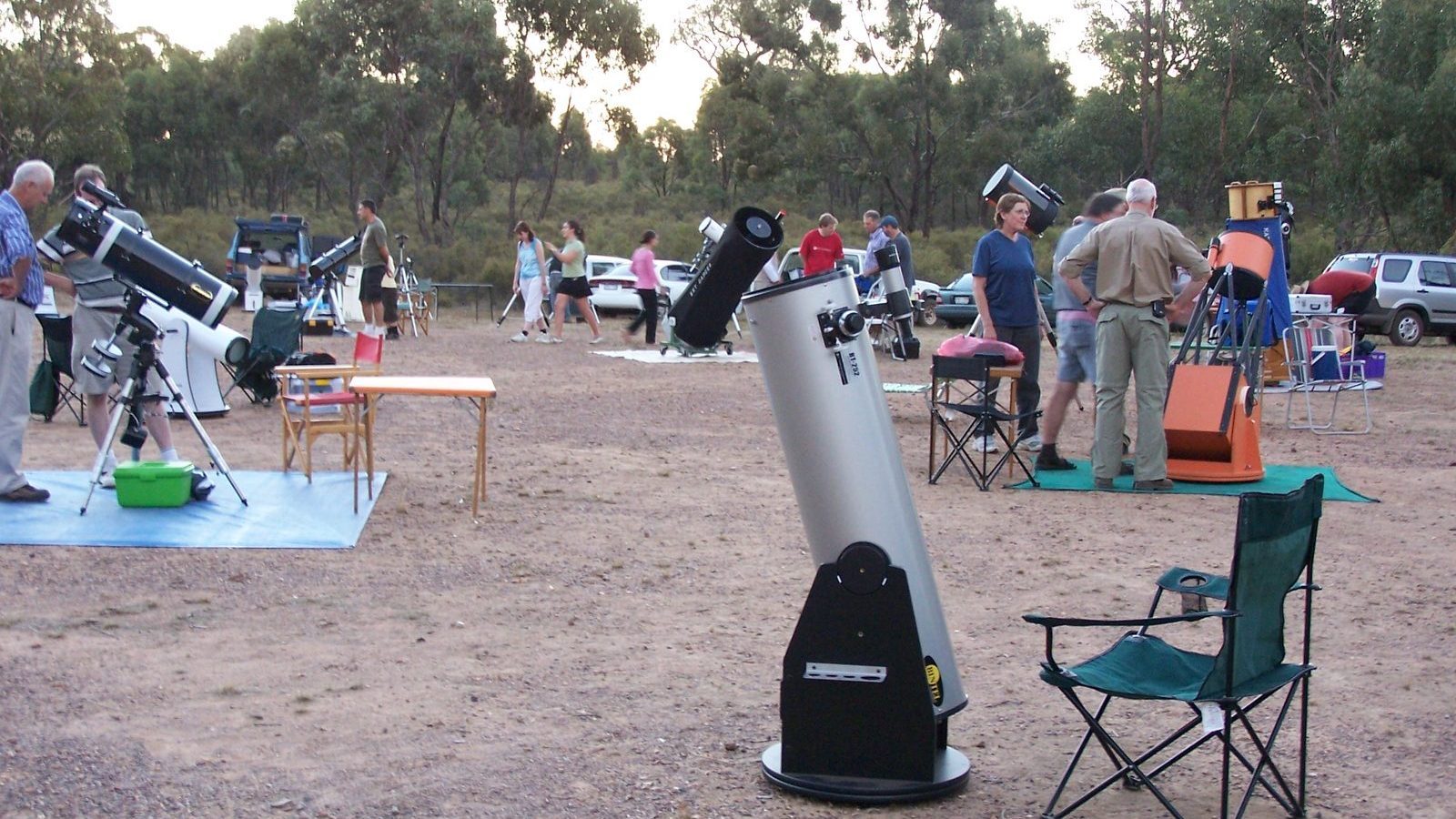 Amateur astronomers setting up large telescopes at a dark-sky site