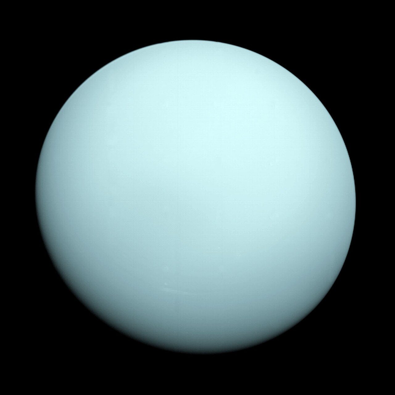 Uranus photographed by Voyager&nbsp;2, showing the featureless pale blue-green disc that a backyard telescope reduces to a small colored dot